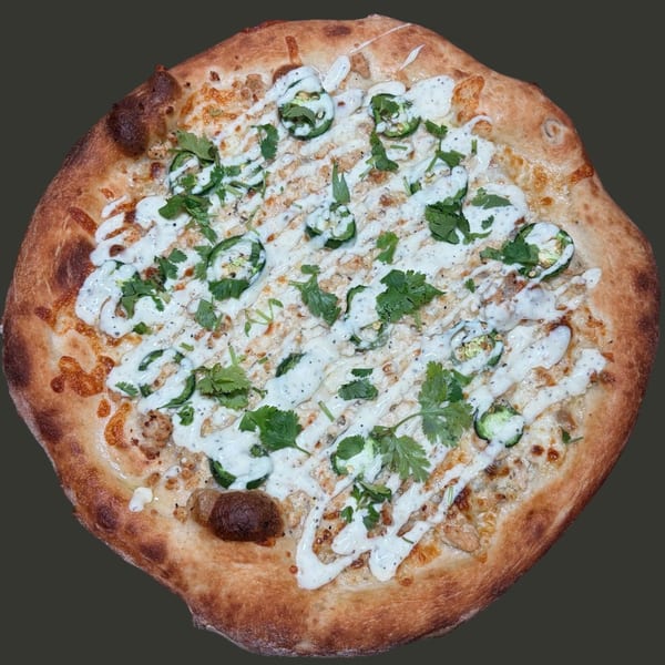 Round pizza with golden crust, creamy white sauce, sliced jalapeños, and fresh cilantro.